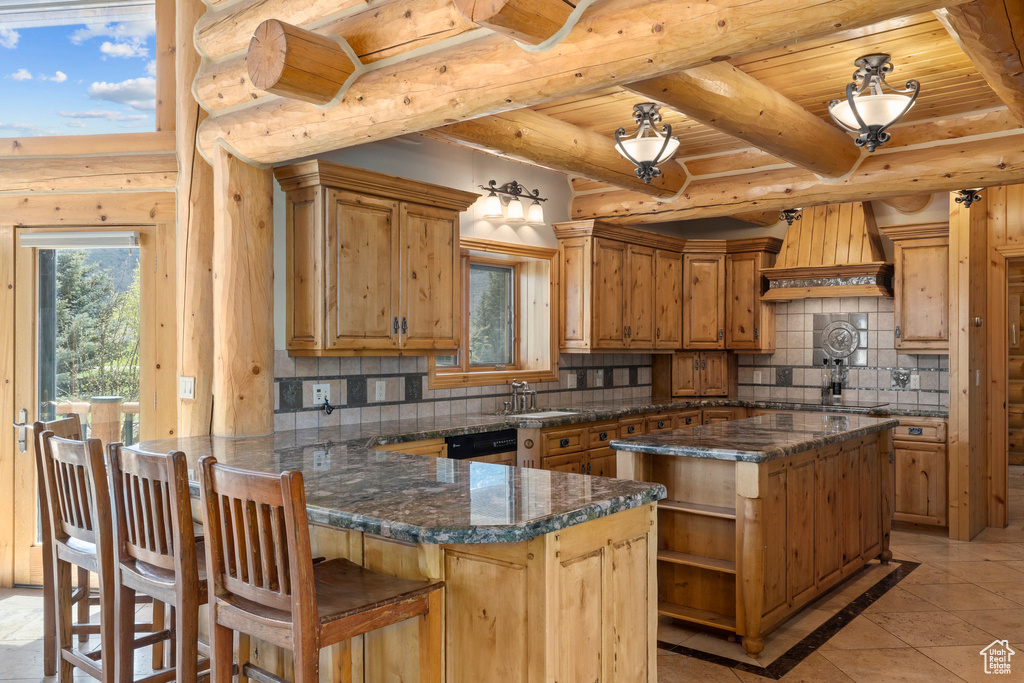 Kitchen with dark stone counters, light tile flooring, wood ceiling, premium range hood, and backsplash