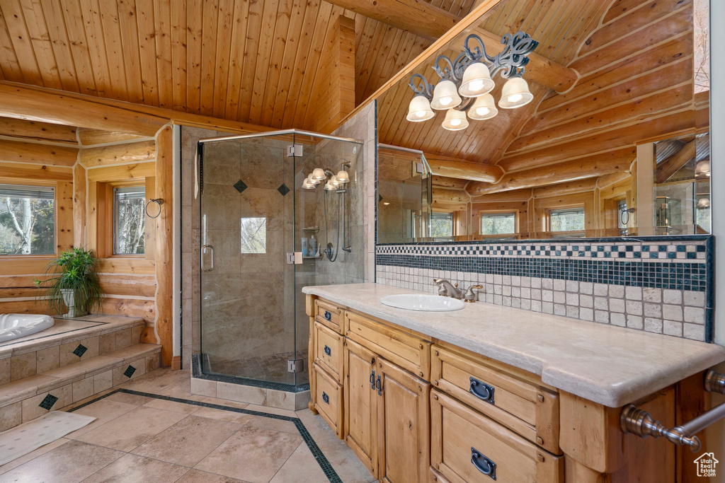 Bathroom with lofted ceiling, rustic walls, and wood ceiling