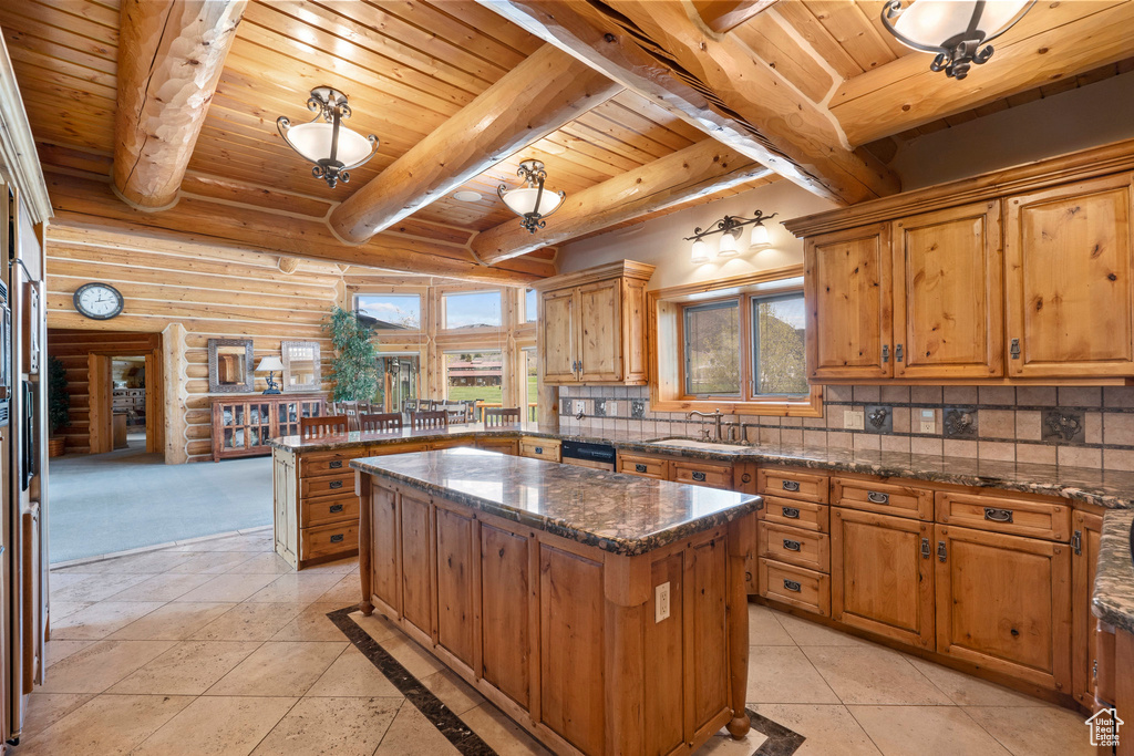 Kitchen featuring a kitchen island, tasteful backsplash, wooden ceiling, sink, and light tile floors