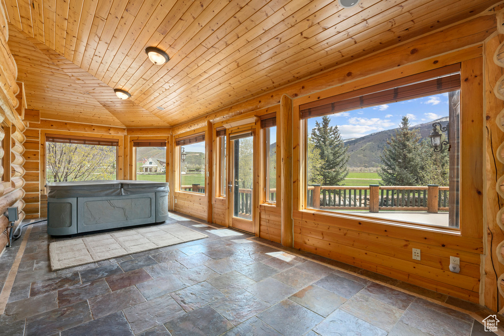 Unfurnished sunroom featuring wooden ceiling