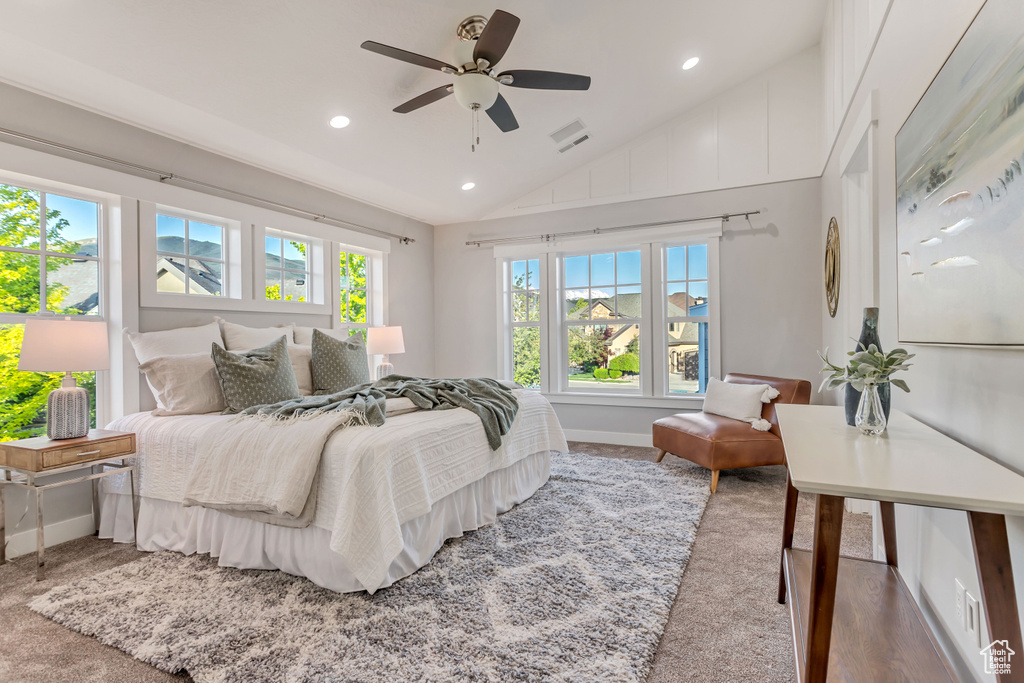 Bedroom with carpet, ceiling fan, and lofted ceiling