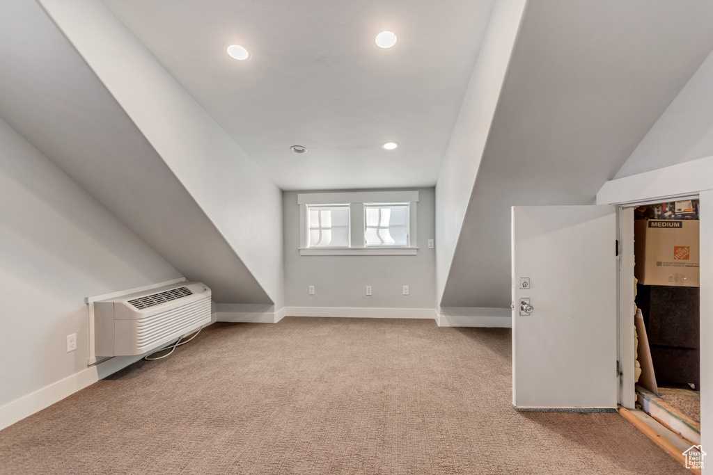 Additional living space featuring light colored carpet