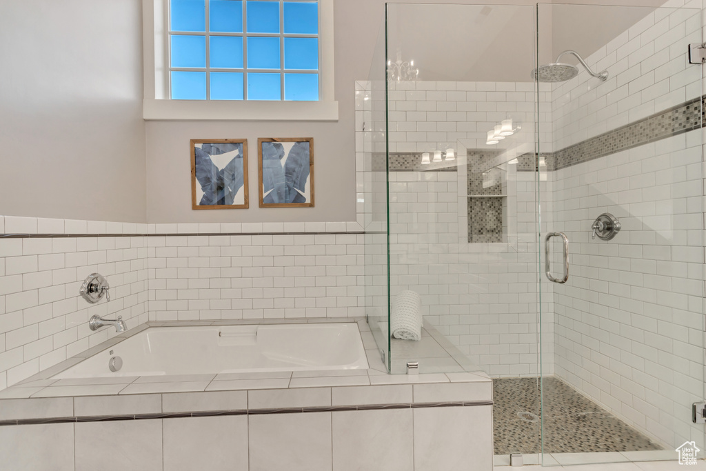 Bathroom with tile walls and shower with separate bathtub