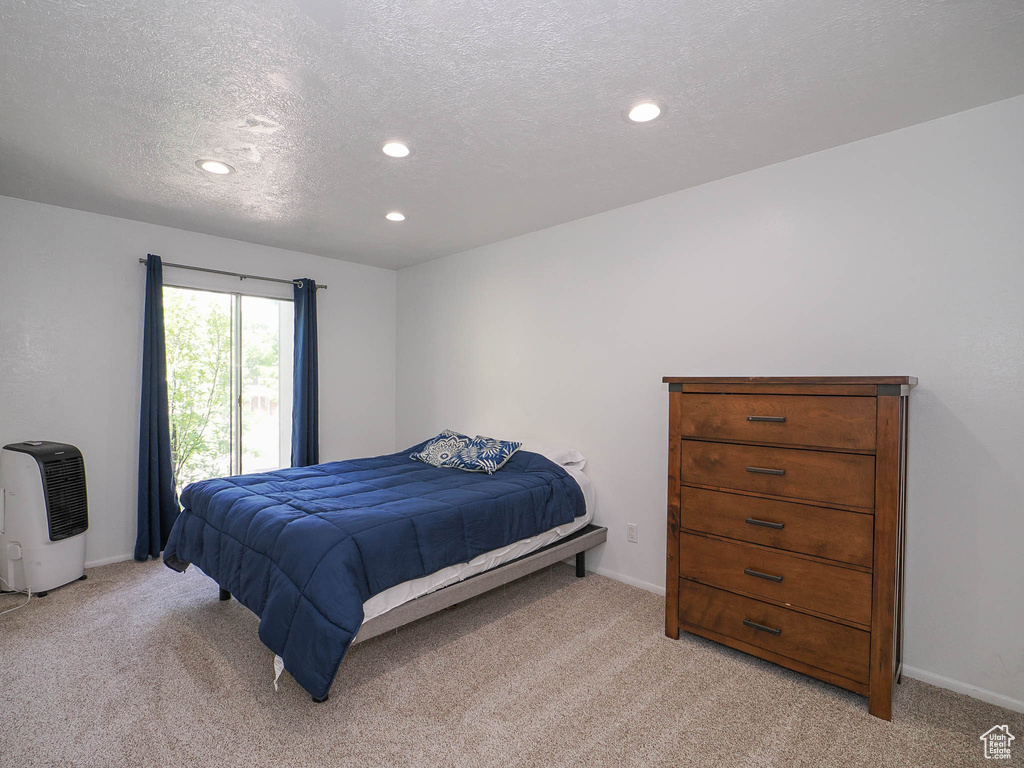 Carpeted bedroom with a textured ceiling