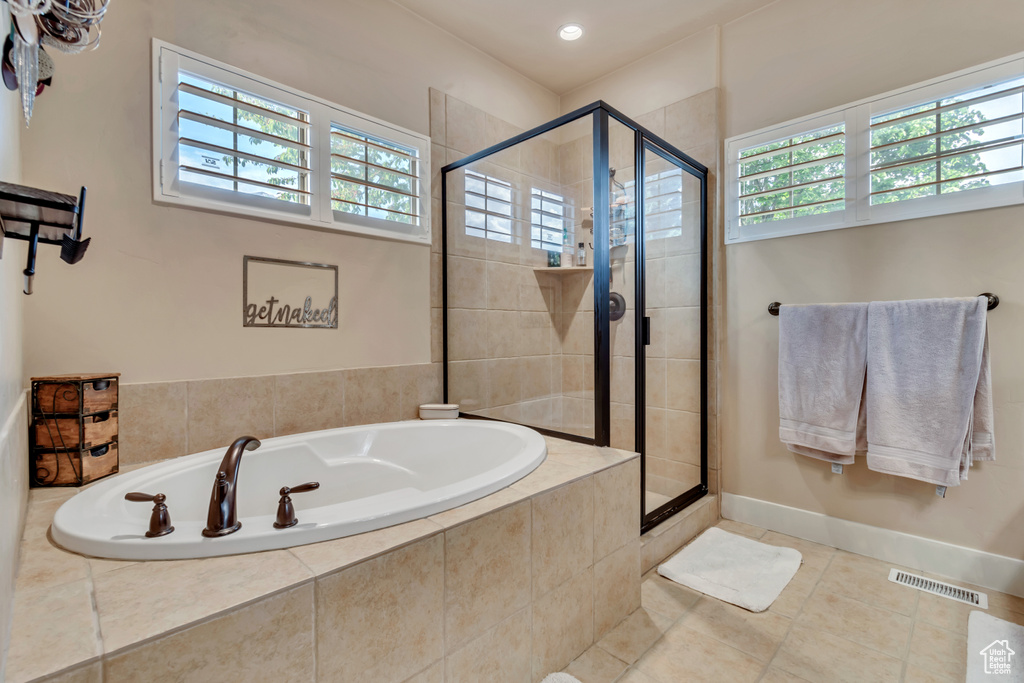 Bathroom featuring tile floors and plus walk in shower