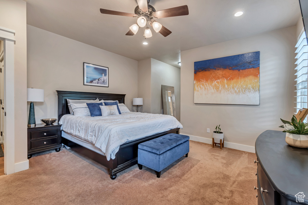 Bedroom featuring ceiling fan and carpet flooring