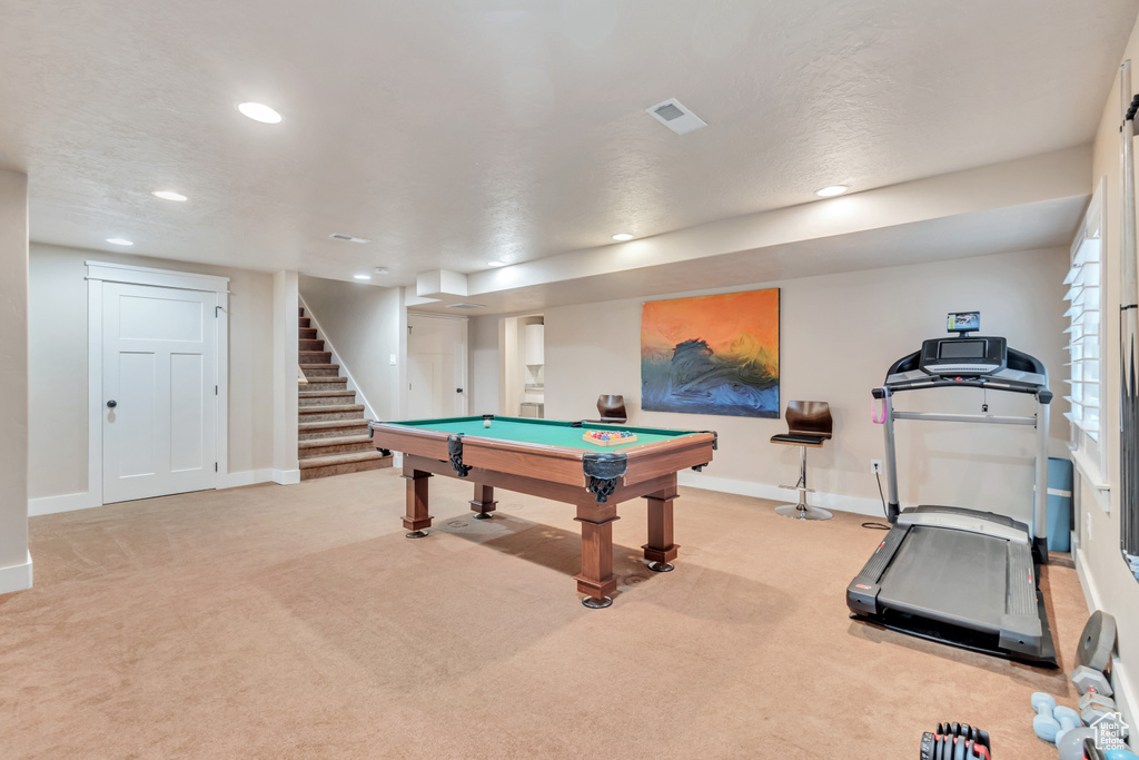 Game room with light colored carpet and billiards