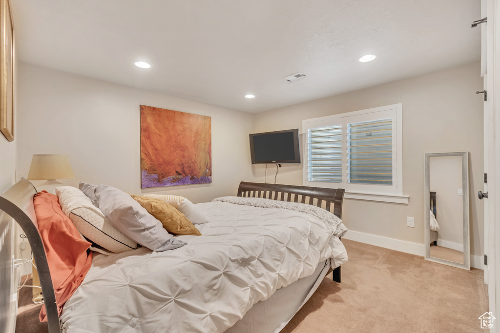 Bedroom featuring light colored carpet