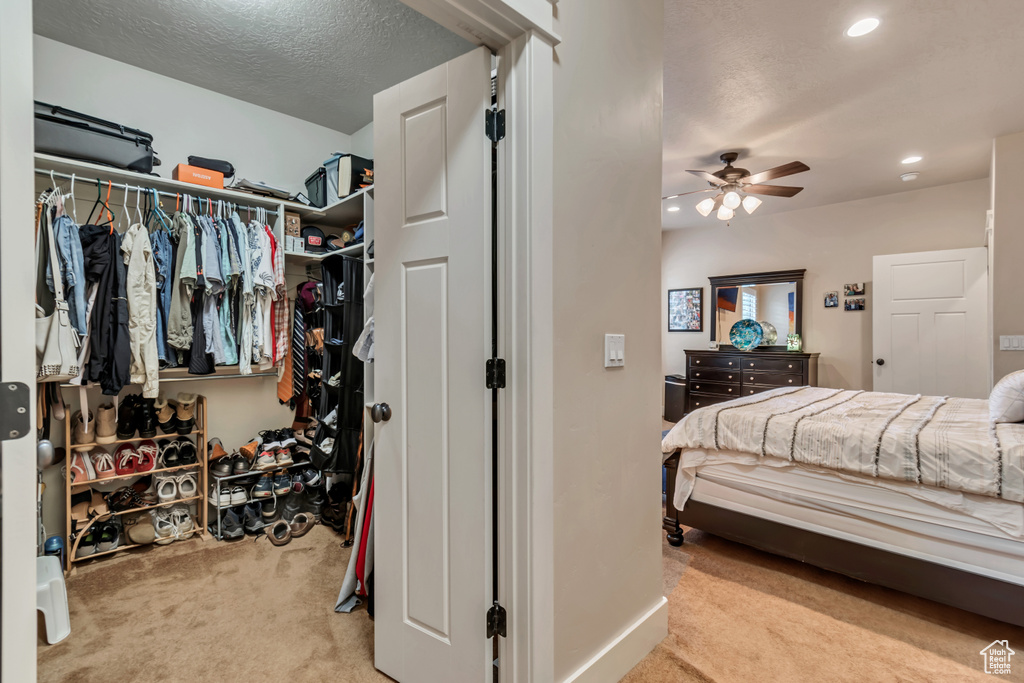 Bedroom featuring a closet, carpet, and ceiling fan