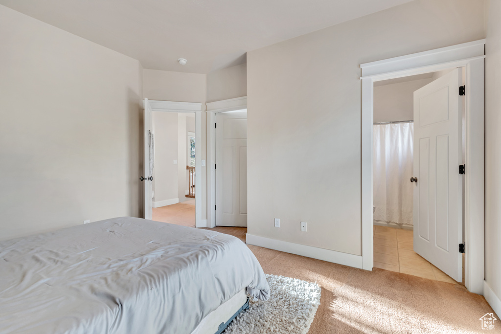 Carpeted bedroom with ensuite bathroom