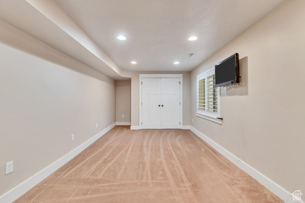 Unfurnished bedroom with light carpet