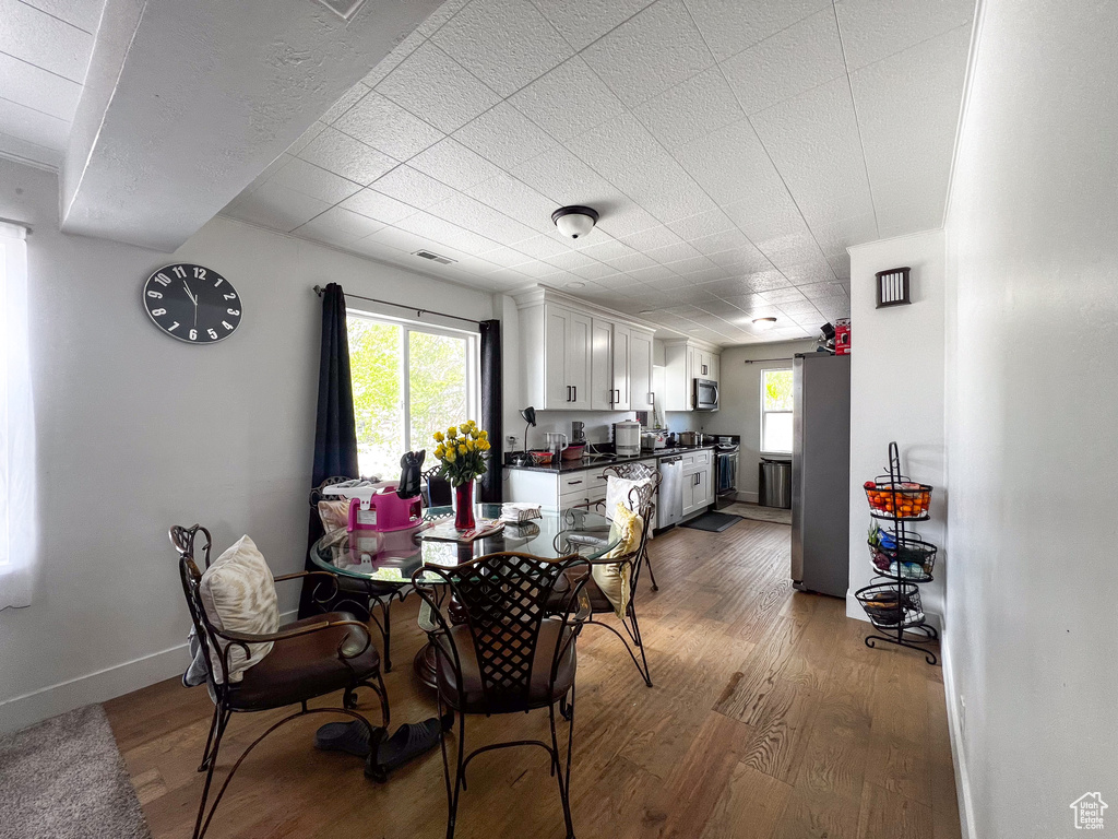 Dining area with hardwood / wood-style floors