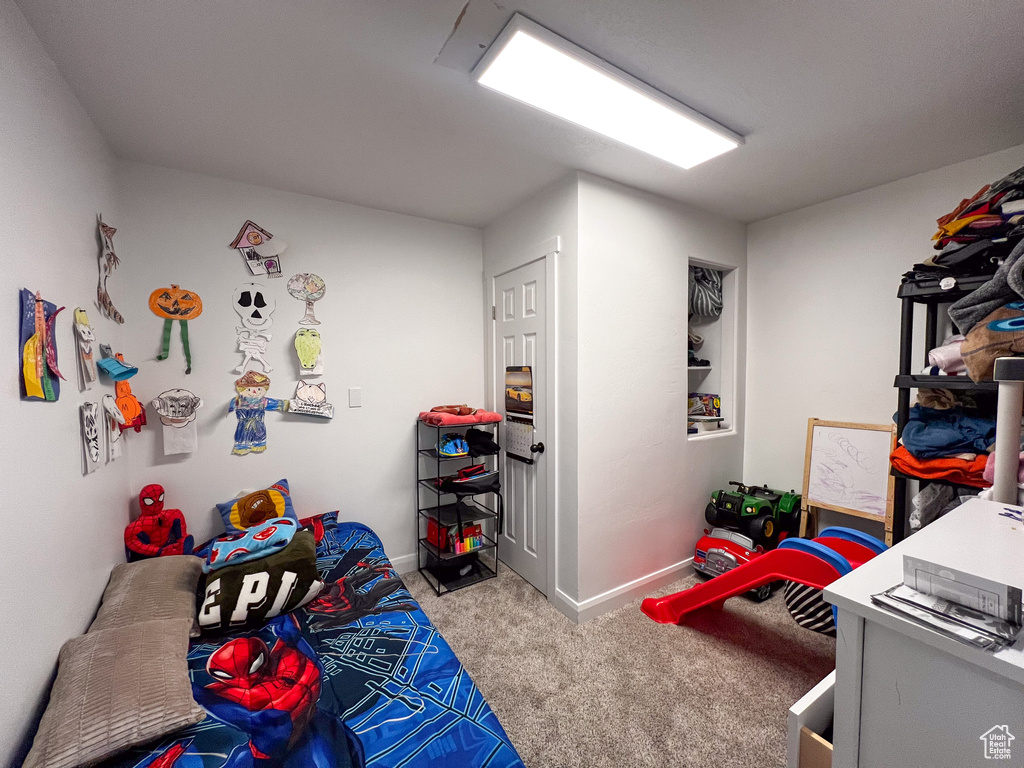 Bedroom featuring light colored carpet