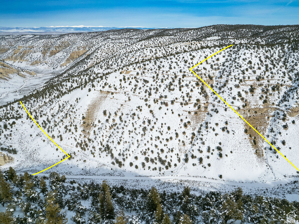 Snowy aerial view featuring a mountain view