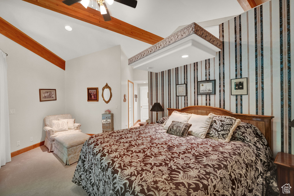 Carpeted bedroom featuring lofted ceiling with beams and ceiling fan