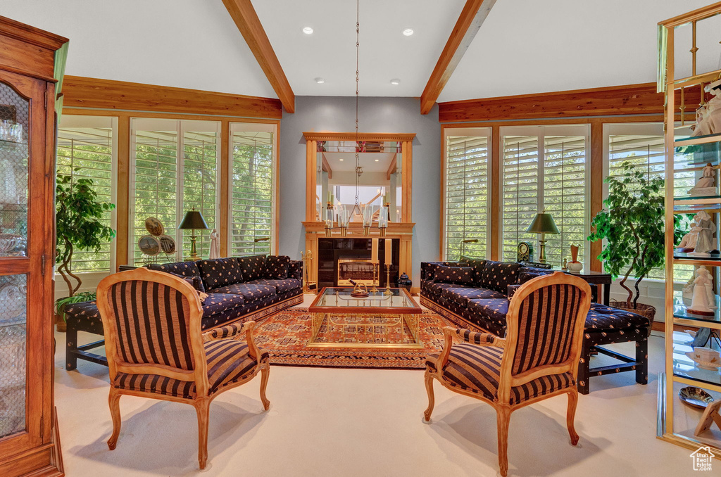 Living room with vaulted ceiling with beams and carpet floors