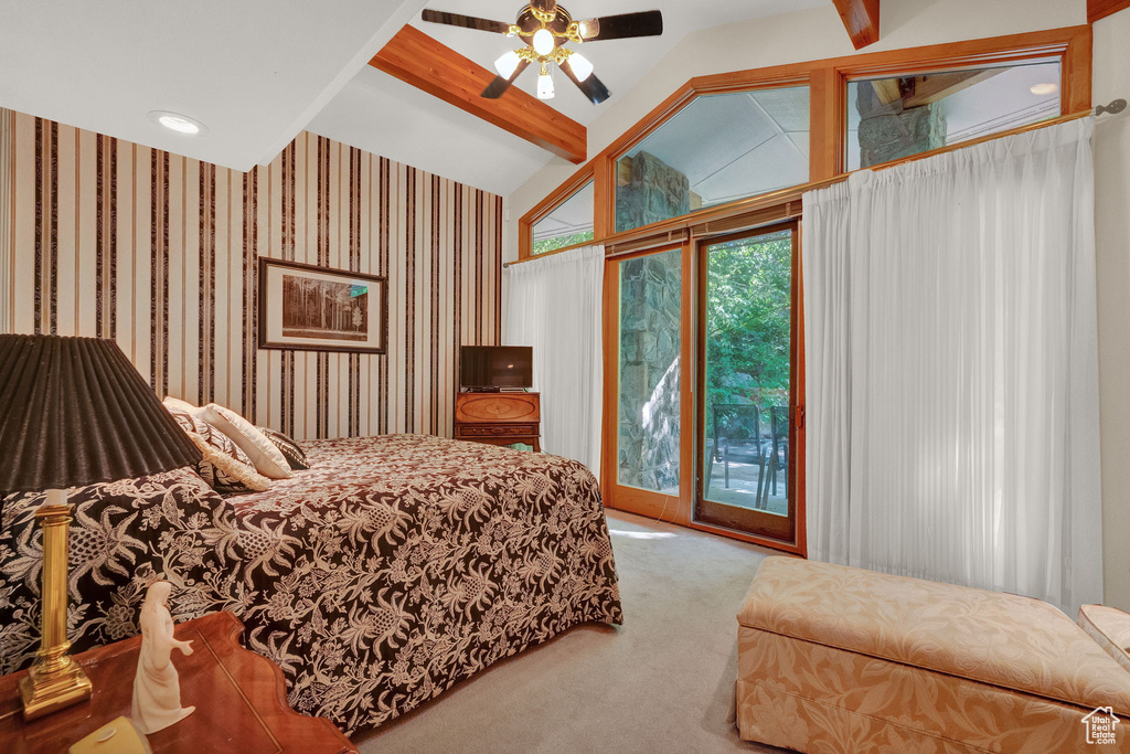 Carpeted bedroom with beamed ceiling, access to exterior, ceiling fan, and high vaulted ceiling