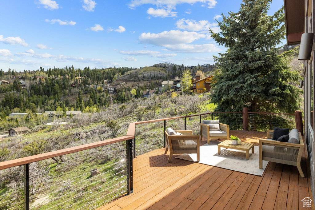 Wooden terrace featuring outdoor lounge area