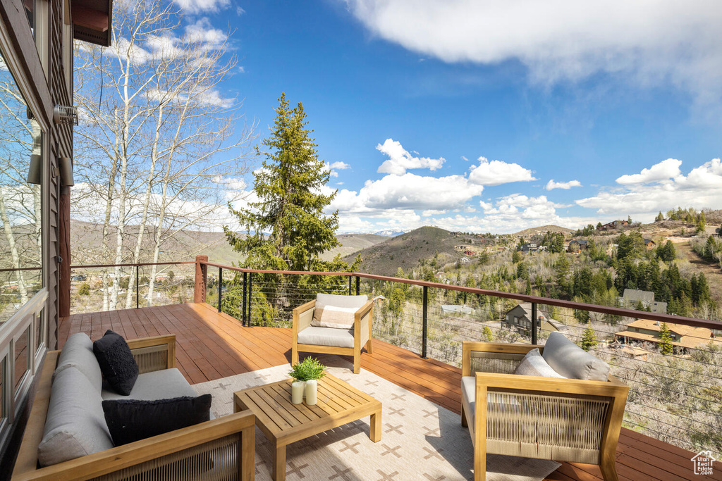 Wooden terrace featuring a mountain view and outdoor lounge area