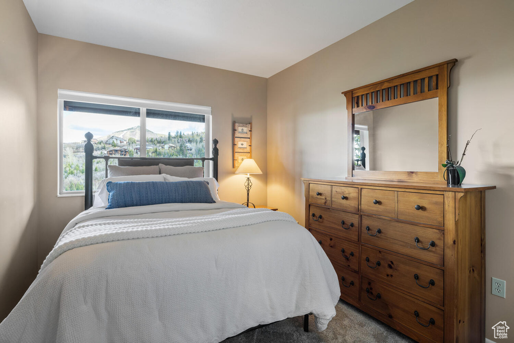 Bedroom featuring dark colored carpet