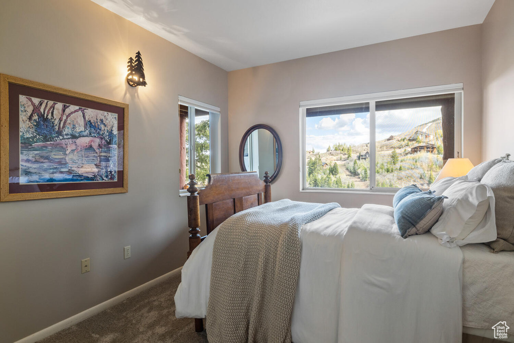 Bedroom featuring dark carpet