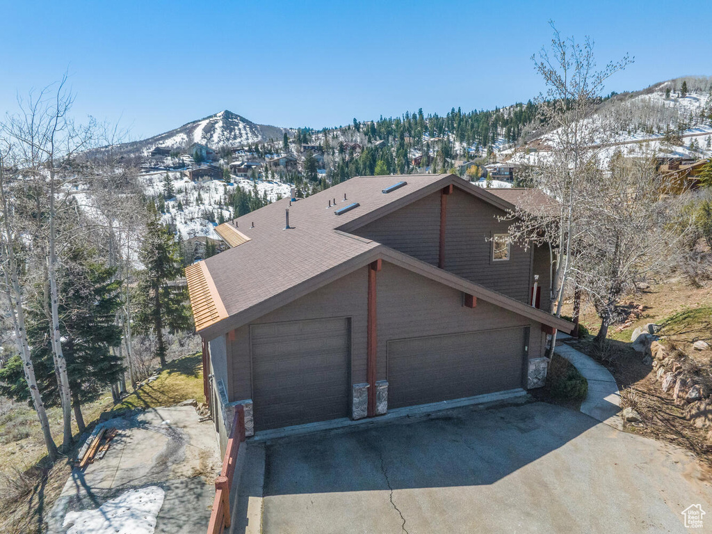 View of front of home featuring a garage and a mountain view