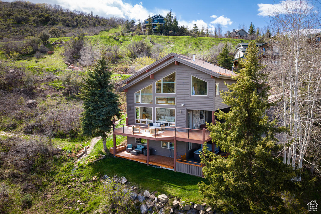 Rear view of house featuring a deck