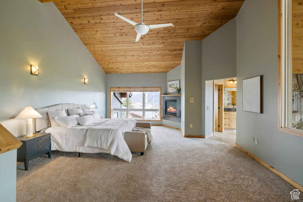 Unfurnished bedroom featuring high vaulted ceiling, wooden ceiling, ceiling fan, and carpet floors