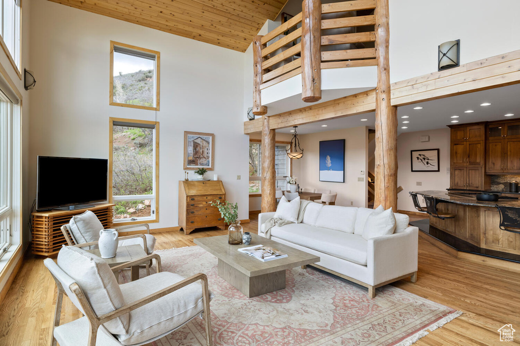 Living room featuring high vaulted ceiling and hardwood / wood-style flooring