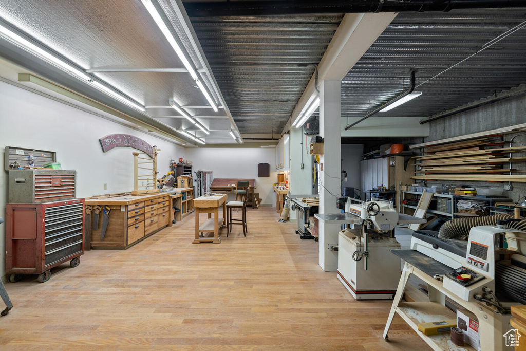 Misc room with a workshop area and light wood-type flooring