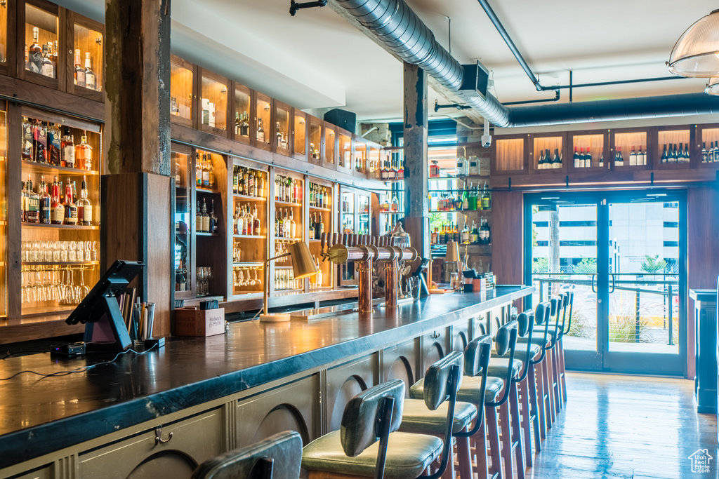 Bar featuring hardwood / wood-style flooring