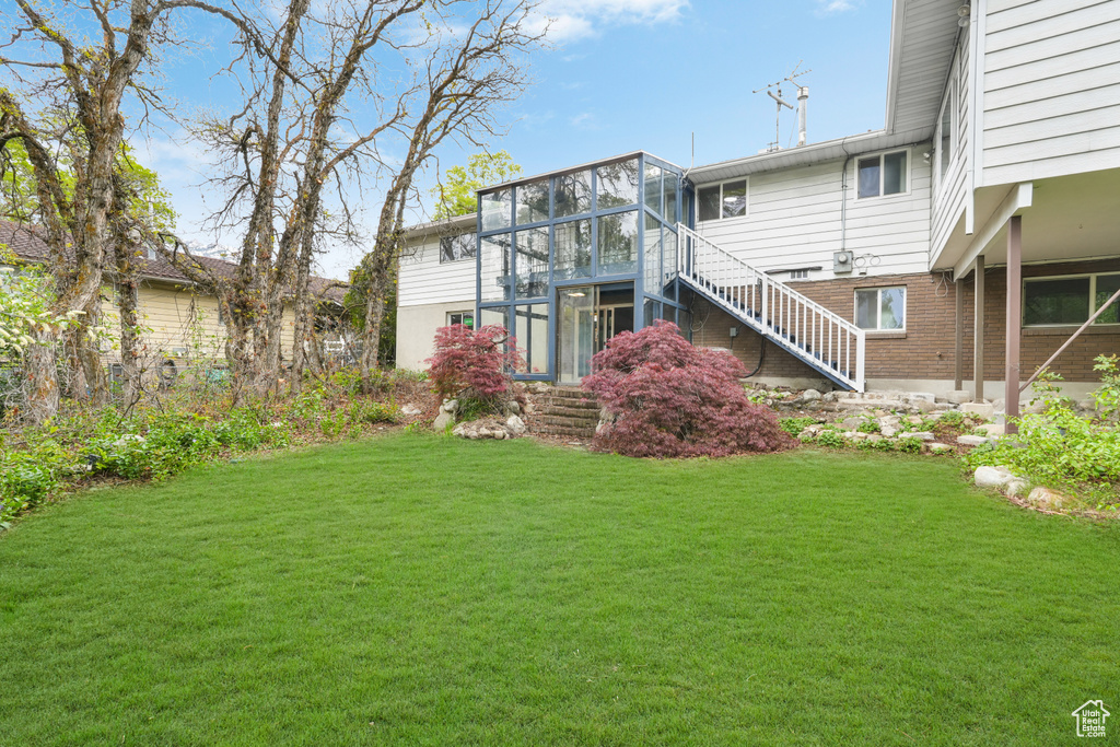 View of yard with a sunroom