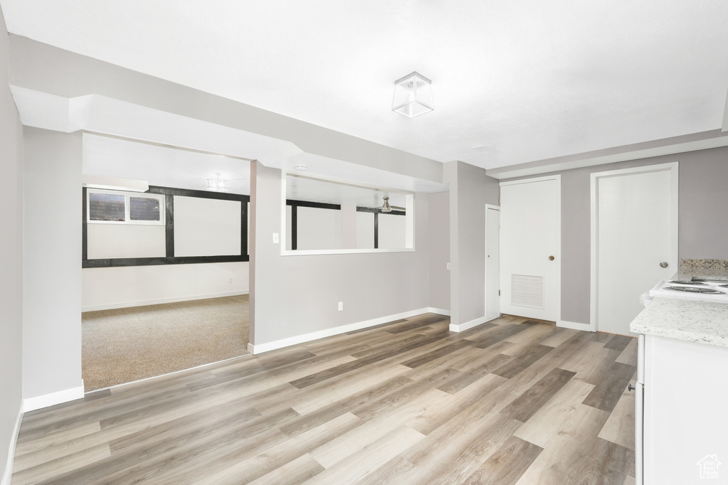 Unfurnished living room with light colored carpet