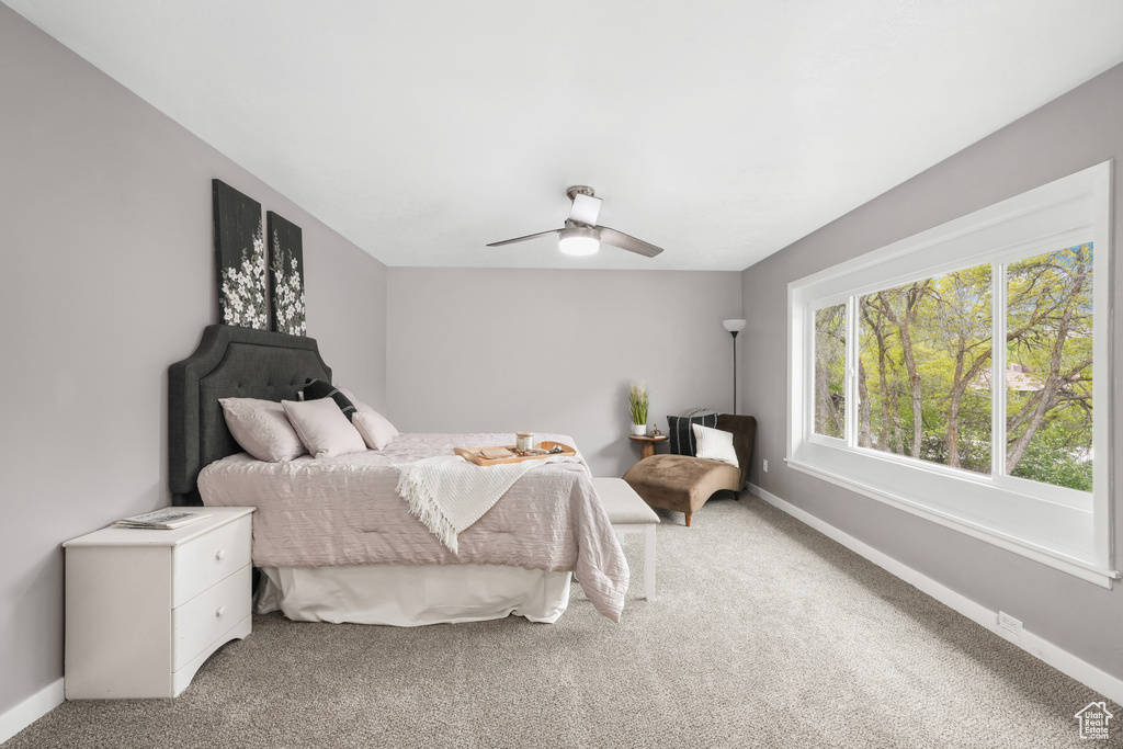 Bedroom with ceiling fan and carpet floors