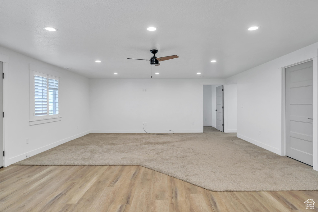 Unfurnished room featuring ceiling fan and light hardwood / wood-style flooring