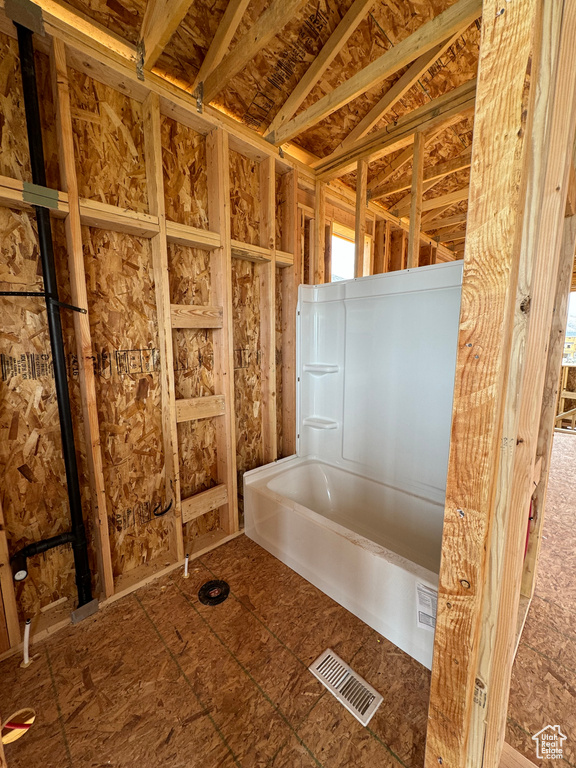 Bathroom featuring vaulted ceiling