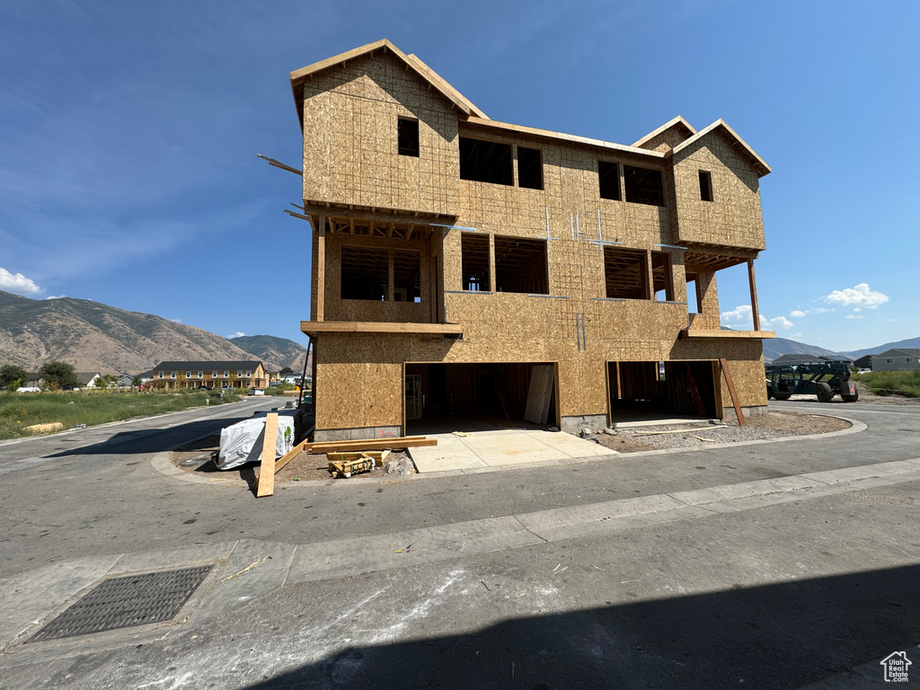 View of front facade featuring a mountain view and a balcony