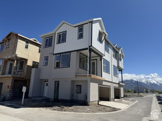 View of property featuring a garage and a mountain view