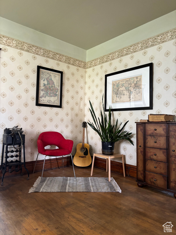 Sitting room with dark hardwood / wood-style flooring