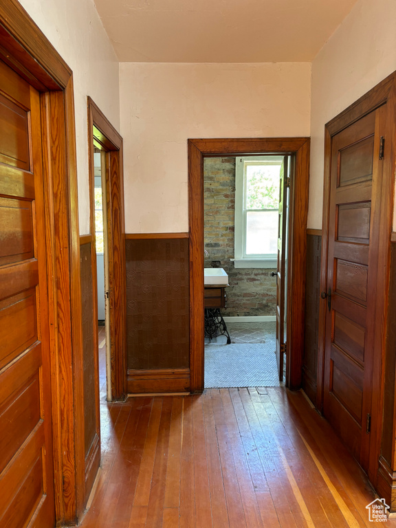 Hallway with hardwood / wood-style floors