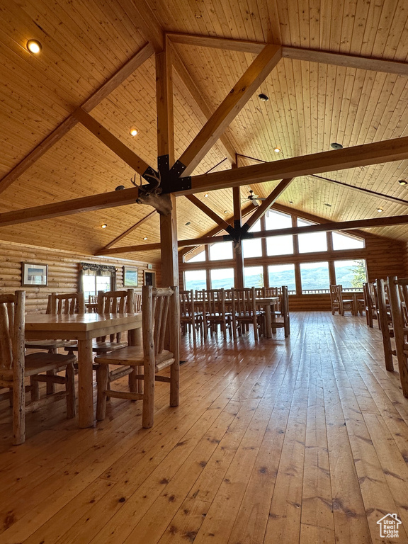 Unfurnished dining area with beamed ceiling, wood ceiling, and wood-type flooring