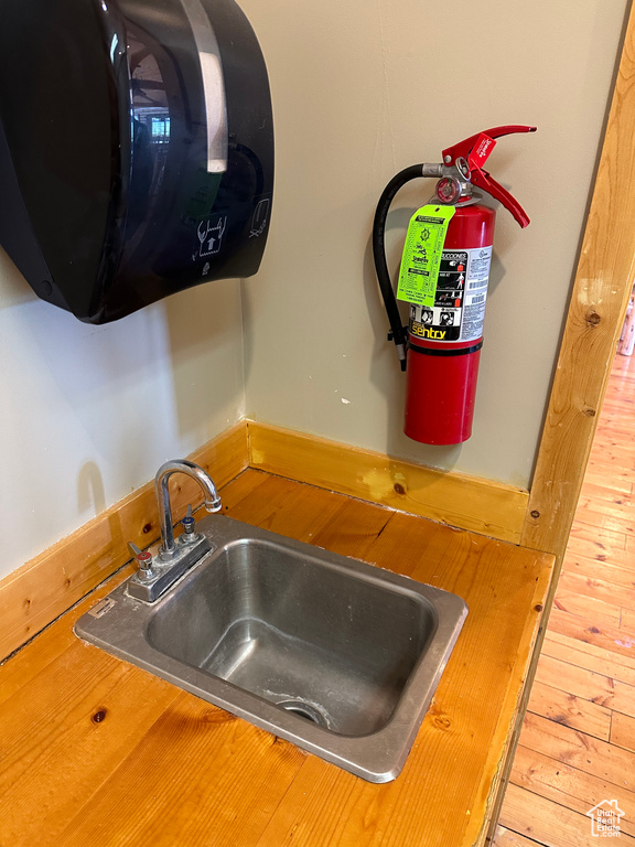 Interior details with sink and hardwood / wood-style flooring