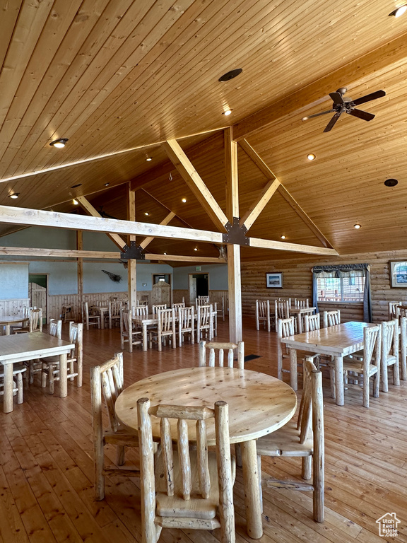 Dining space with wood ceiling, ceiling fan, vaulted ceiling, and light hardwood / wood-style flooring