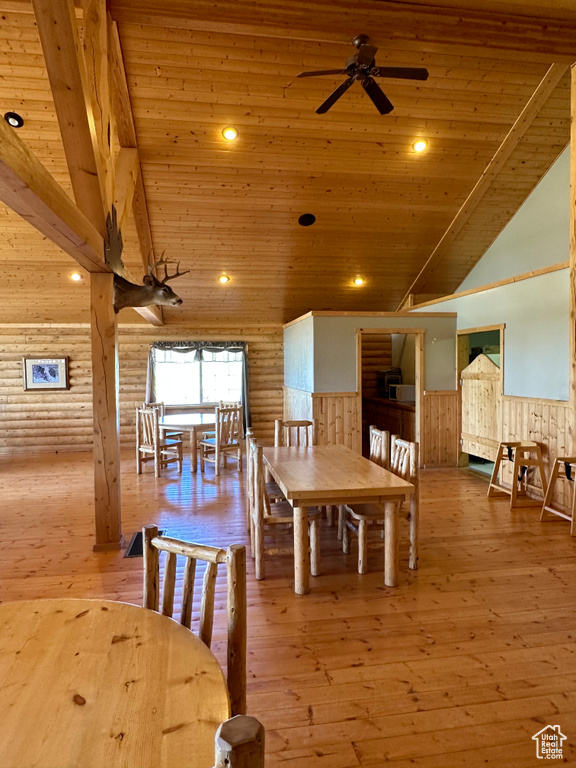 Dining space featuring light hardwood / wood-style flooring, vaulted ceiling, and wooden ceiling