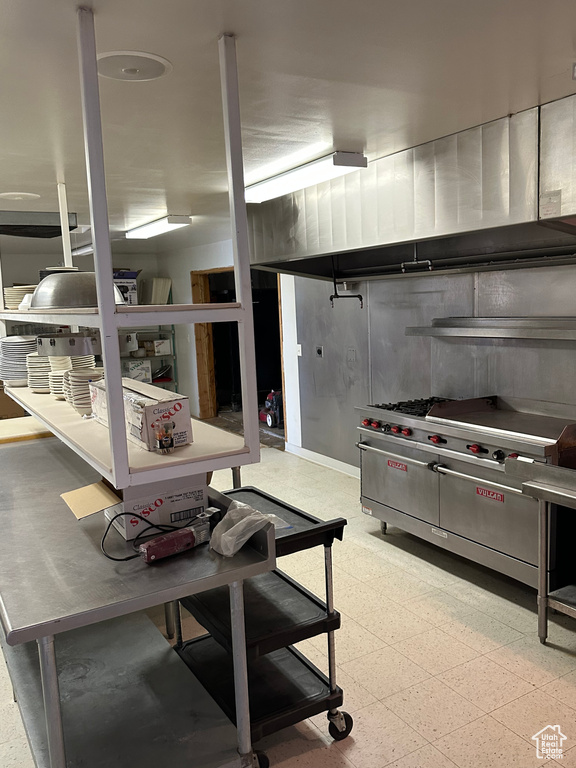 Kitchen featuring stainless steel counters and light tile flooring