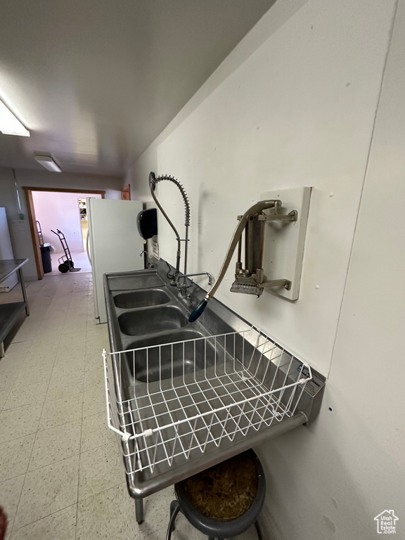 Details featuring tile floors and white fridge