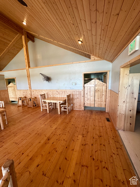 Unfurnished dining area with vaulted ceiling, hardwood / wood-style floors, and wood ceiling