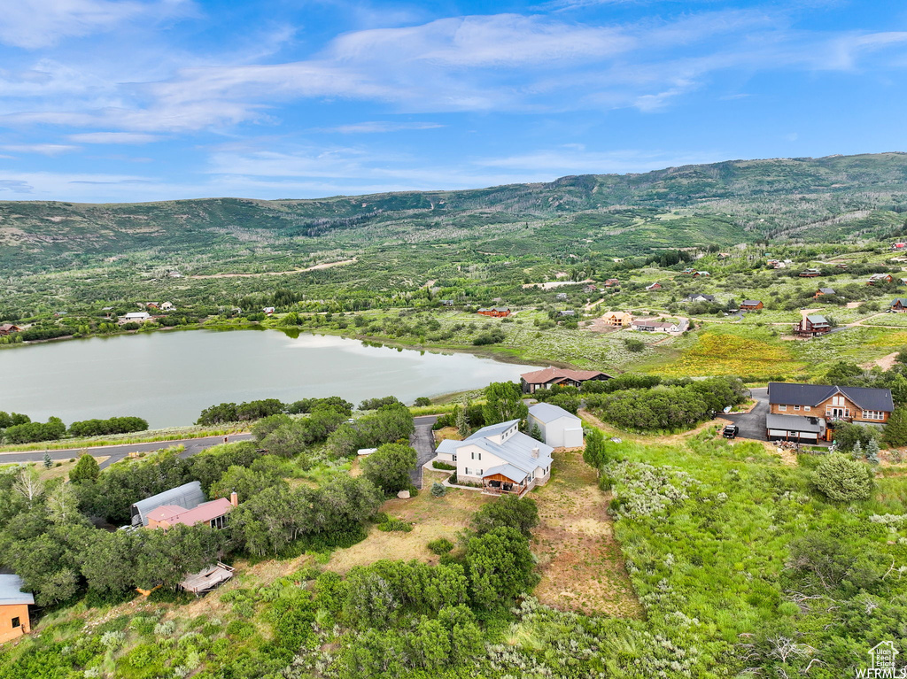 Drone / aerial view with a water and mountain view