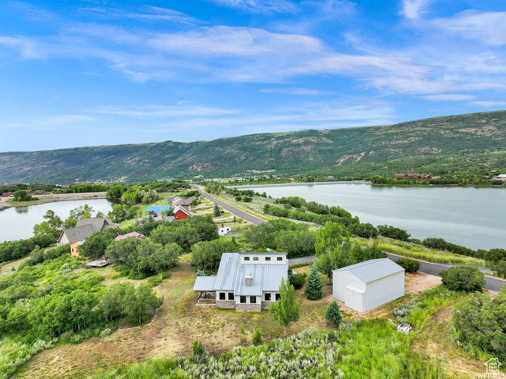 Drone / aerial view with a water and mountain view