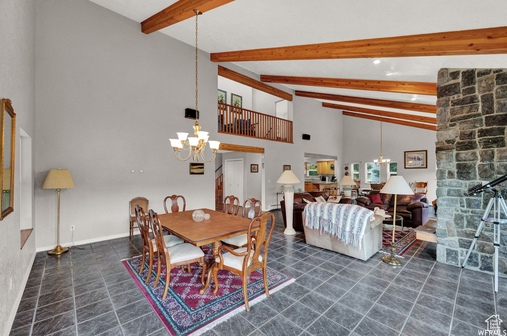 Tiled dining room with high vaulted ceiling, beam ceiling, and an inviting chandelier